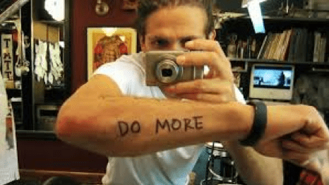 Casey Neistat taking selfie of "Do More" tattoo in make it count video