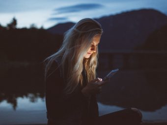 Girl checking social media, which may have a negative effect on her mental health
